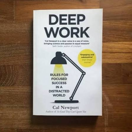 Deep Work by Cal Newport — white cover with a desk lamp and a cone of yellow light.
